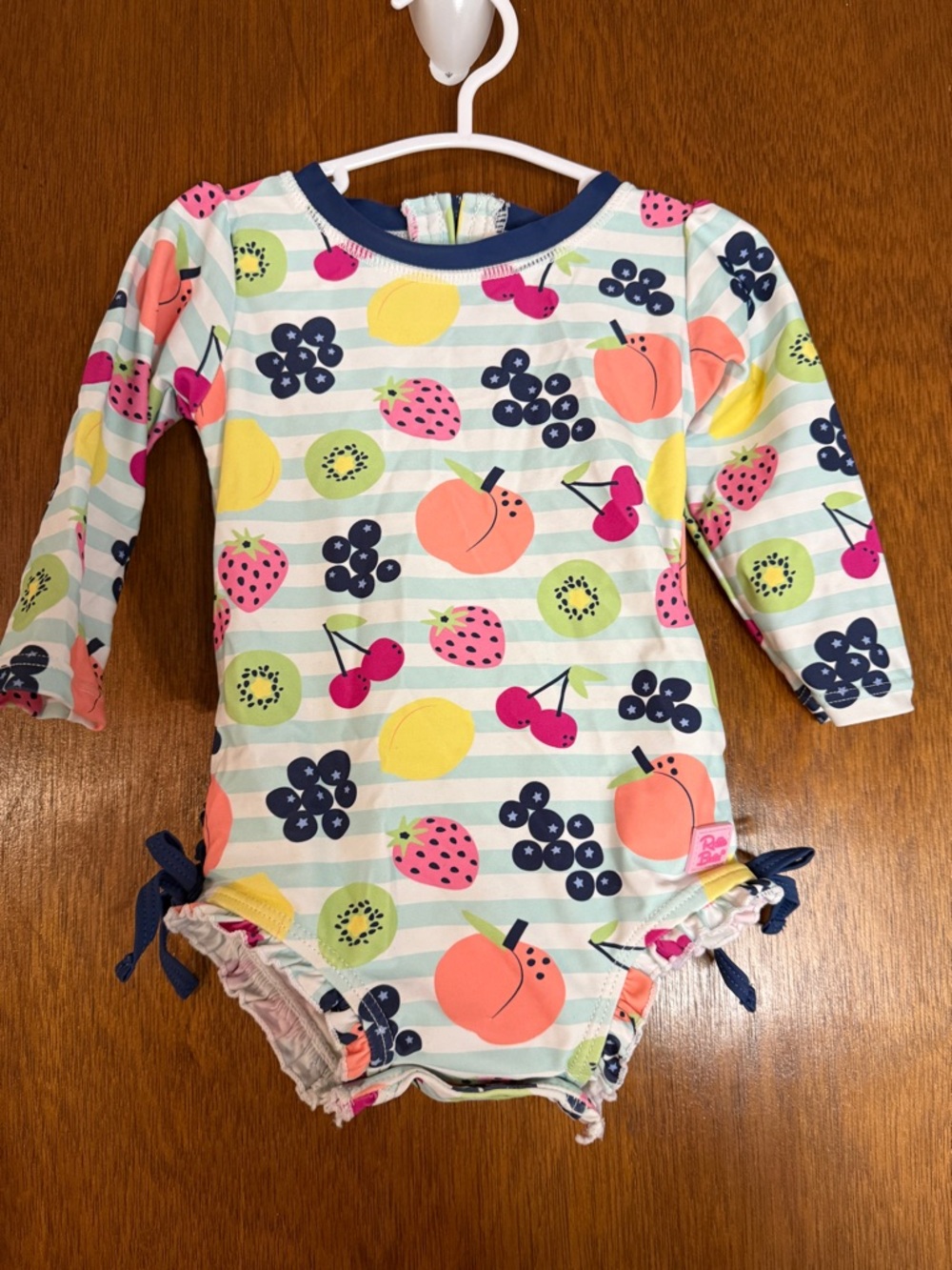 Ruffle Butts Long-Sleeve Fruit Print One-Piece in Coral, Pink, Yellow, Navy